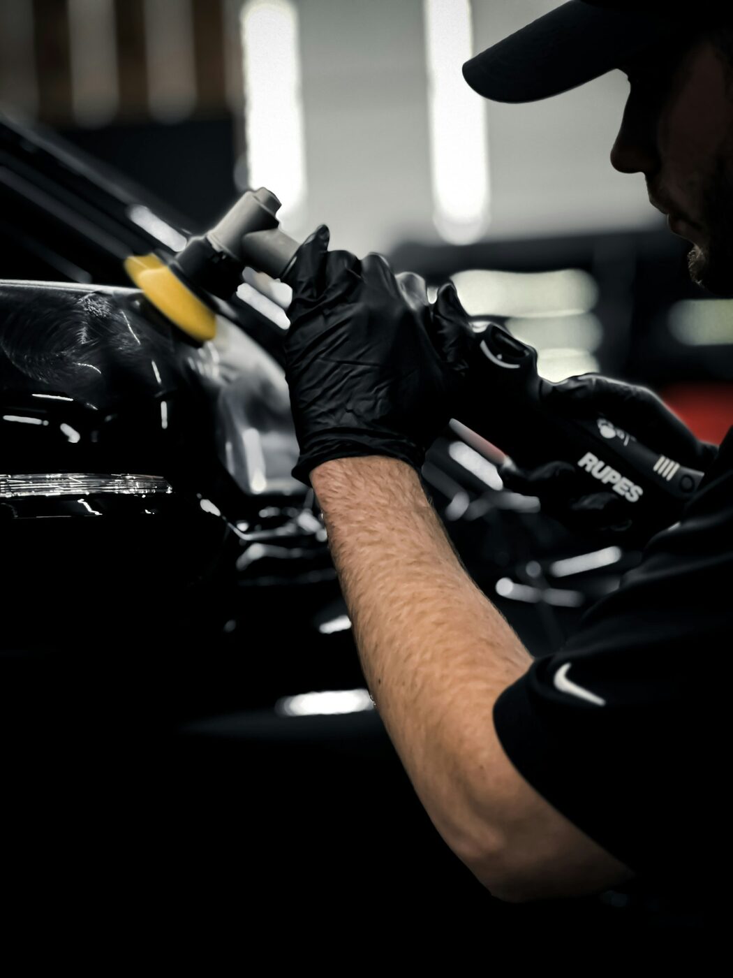 A detailer machine polishing a panel inside the unit